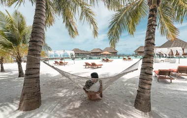 Couple relaxing on a hammock.