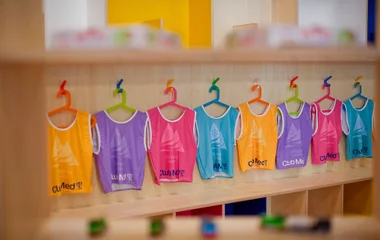 Baby clothes on hangers.